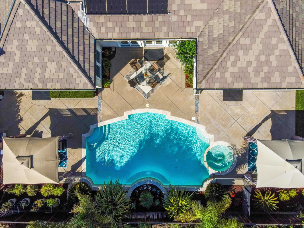 Top down view of home with pool in backyard